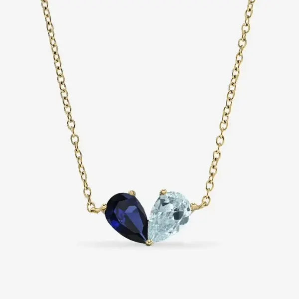 Gold Chérie necklace with a sapphire and an aquamarine pear stone
